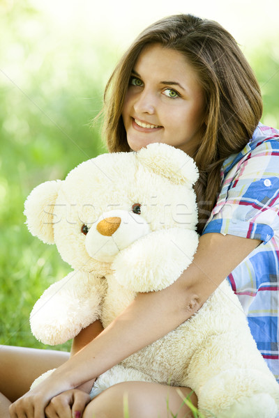 Güzel genç kız oyuncak ayı park yeşil ot kız Stok fotoğraf © Massonforstock