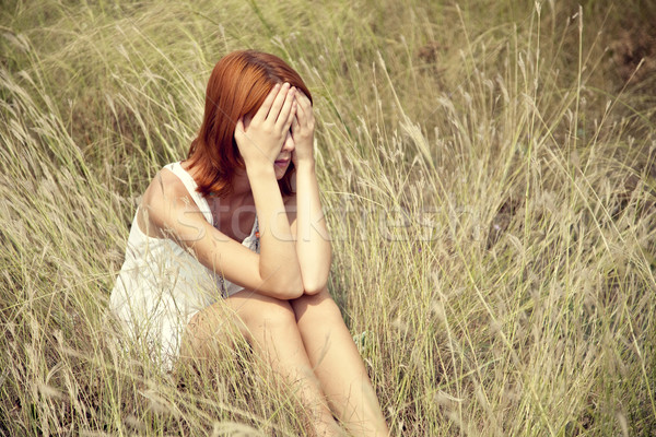 Sad red-haired girl at grass. Stock photo © Massonforstock