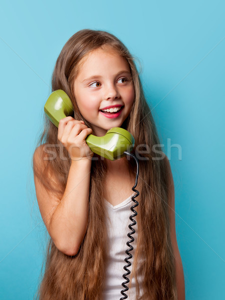 Young smiling girl with green handset  Stock photo © Massonforstock