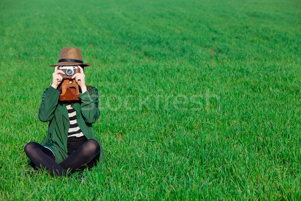beautiful young woman taking a photo with her camera on the wond Stock photo © Massonforstock