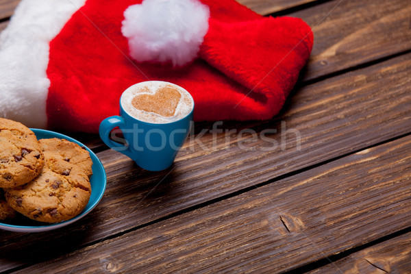 photo of delicious fresh croissant, santa claus hat and cup of c Stock photo © Massonforstock