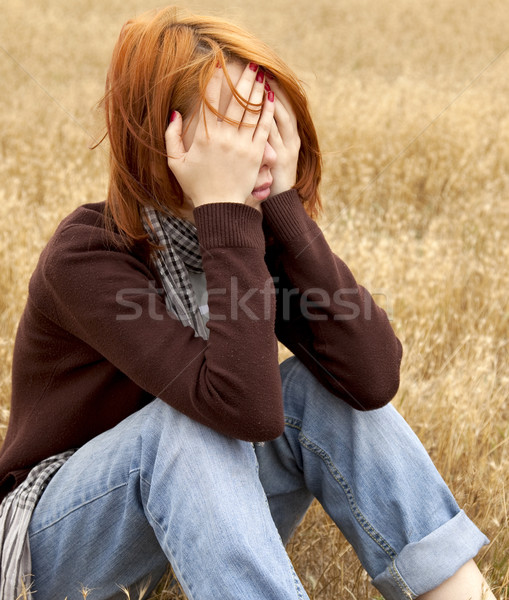 Lonely sad red-haired girl at field Stock photo © Massonforstock