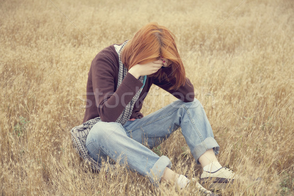 Lonely sad red-haired girl at field Stock photo © Massonforstock