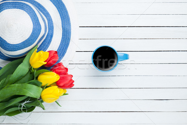 Cup of coffee with hat and tulips  Stock photo © Massonforstock