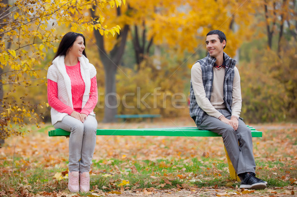 Stock photo: photo of cute couple sitting on the bench on the wonderful autum