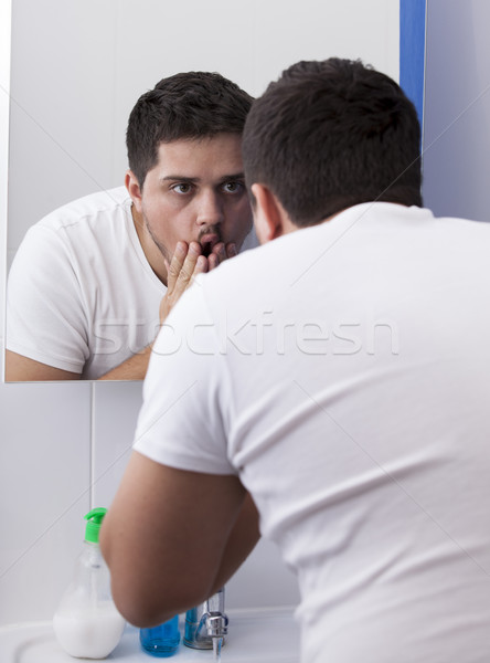 Stock photo: Surprised men near mirror.