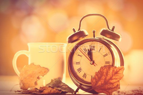 Vintage relógio copo amarelo bokeh mãos Foto stock © Massonforstock