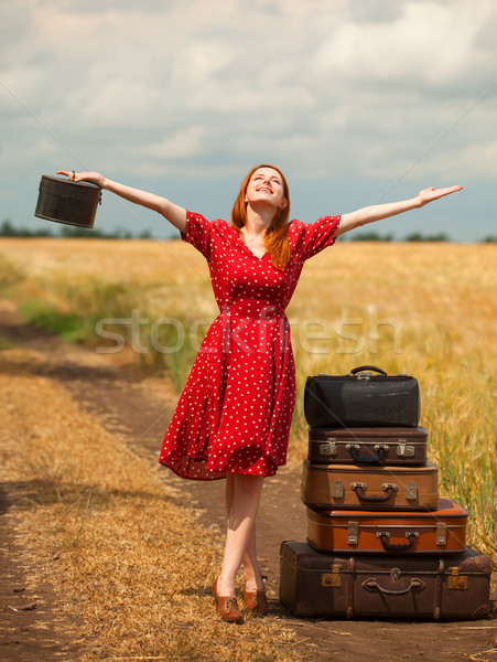 Redhead girl with suitcases at outdoor. Stock photo © Massonforstock