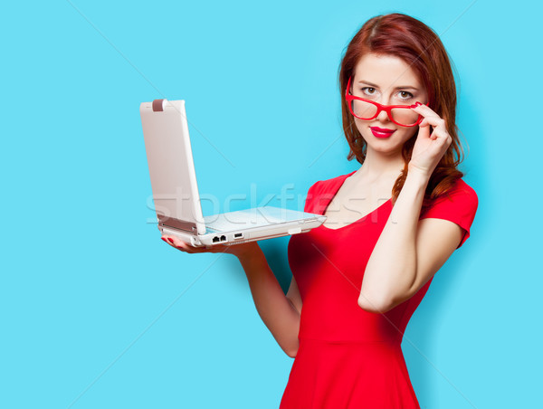photo of beautiful young woman holding laptop on the wonderful b Stock photo © Massonforstock