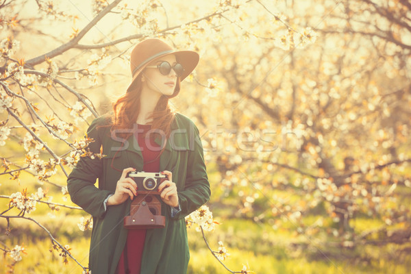 women with camera in blossom apple tree garden  Stock photo © Massonforstock