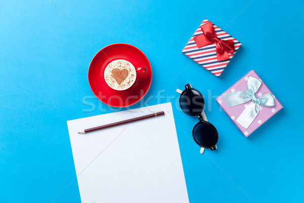 paper, cup, glasses and gift lying on the table Stock photo © Massonforstock