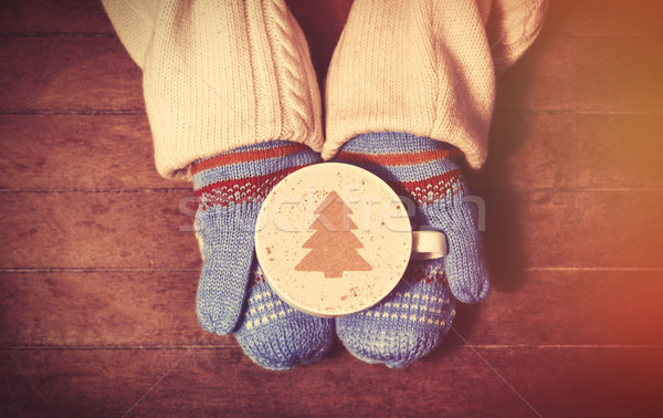 Hands in mittens holding hot cup of coffee Stock photo © Massonforstock