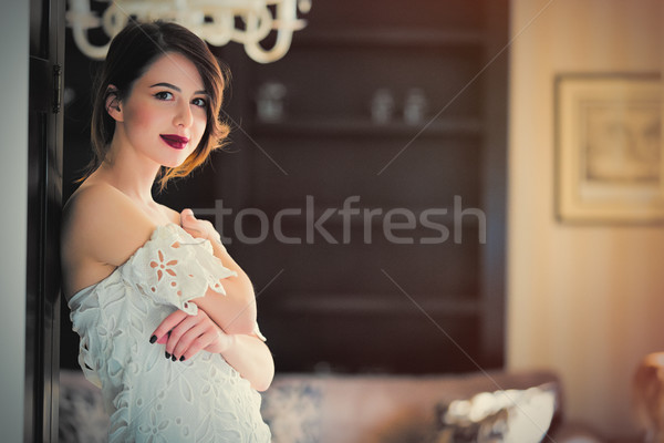 beautiful young woman standing near the door in the light luxury Stock photo © Massonforstock