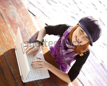 Portrait of red-haired girl with laptop at beach.  Stock photo © Massonforstock