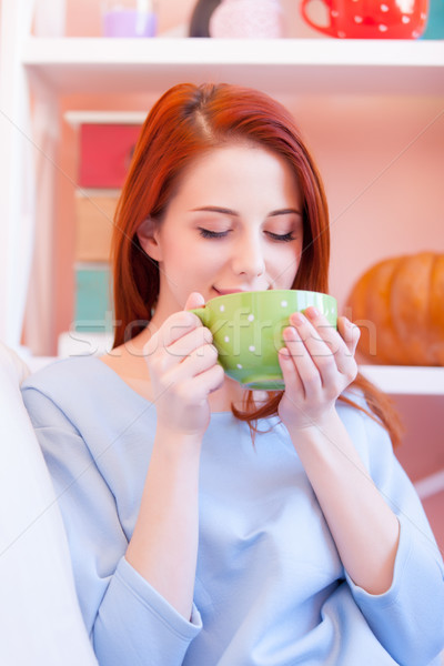 photo of beautiful young woman drinking her fresh coffee and rel Stock photo © Massonforstock