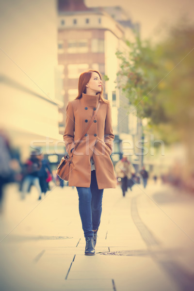 photo of beautiful young woman on one of the streets exploring t Stock photo © Massonforstock