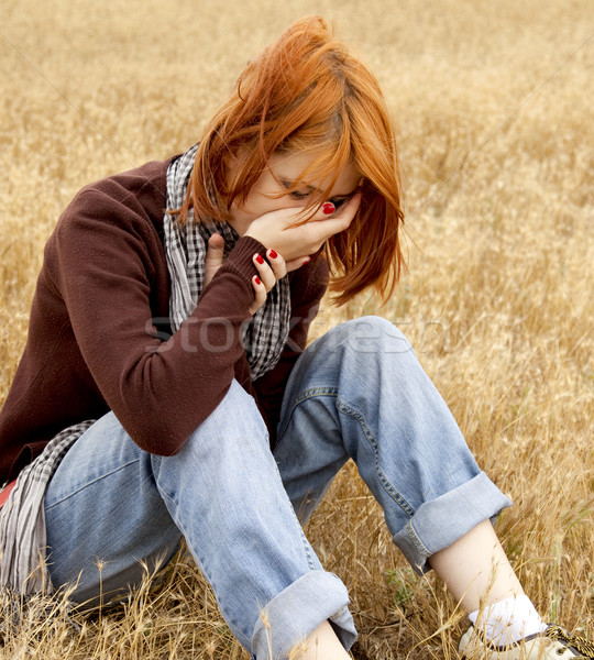 Lonely sad red-haired girl at field Stock photo © Massonforstock