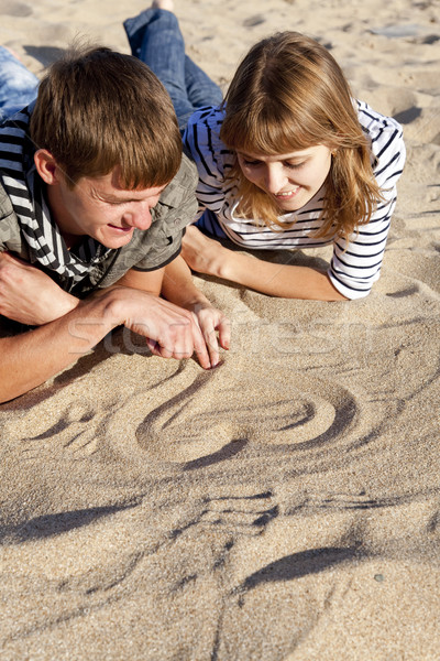People drawing heart at sand Stock photo © Massonforstock