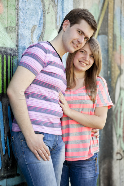 Young couple near graffiti background. Stock photo © Massonforstock