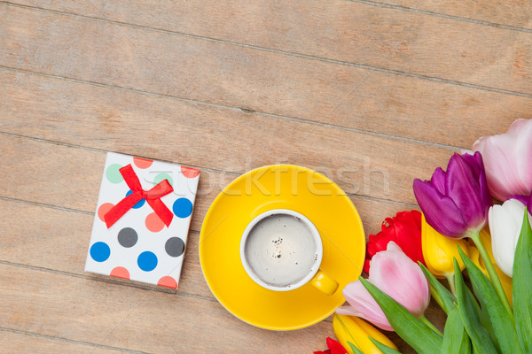 photo of cup of coffee, cute gift and colorful tulips on the won Stock photo © Massonforstock