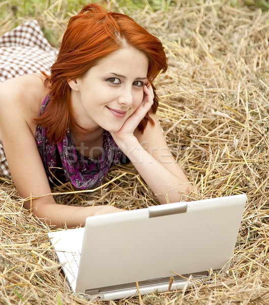 Stock photo: Young  fashion girl with notebook lying at field