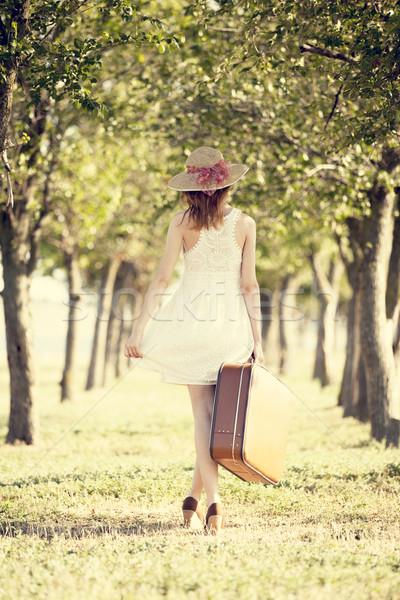 Meisje koffer bomen steegje vrouwen Stockfoto © Massonforstock