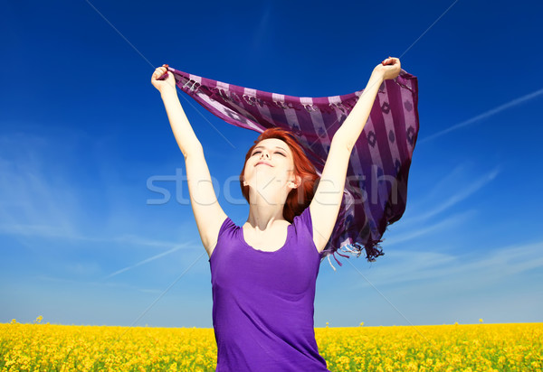 Young woman with open arms keep yellow silk on wind at rapeseed  Stock photo © Massonforstock