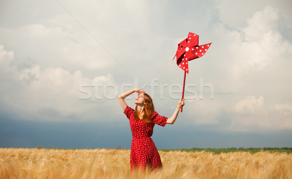 Vörös hajú nő lány játék szélturbina felhők nők Stock fotó © Massonforstock