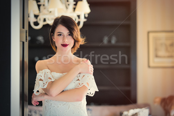 beautiful young woman standing near the door in the light luxury Stock photo © Massonforstock