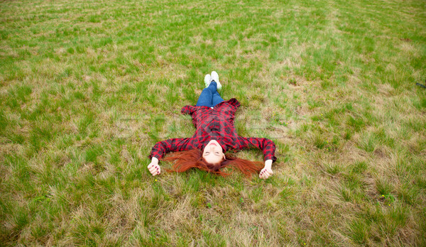 beautiful young woman lying on the field and relaxing on the won Stock photo © Massonforstock