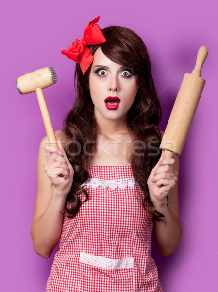 photo of beautiful young woman in apron with rolling pin and ham Stock photo © Massonforstock
