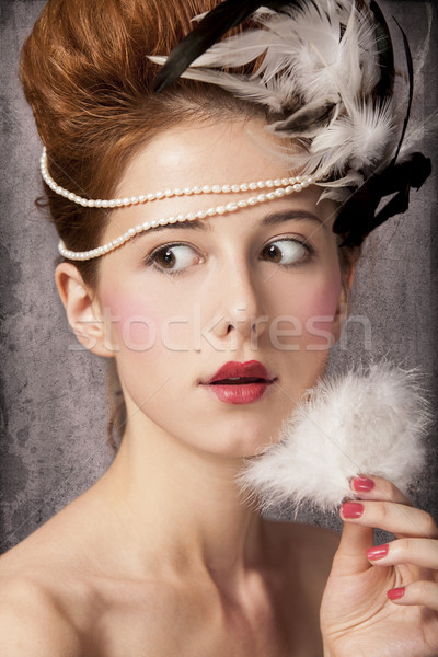 Surprised redhead girl with Rococo hair style at vintage backgro Stock photo © Massonforstock