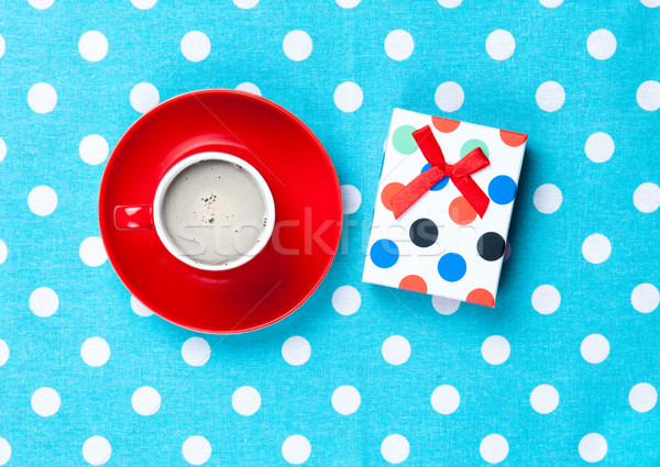 photo of cup of coffee and cute gift on the wonderful blue dotte Stock photo © Massonforstock