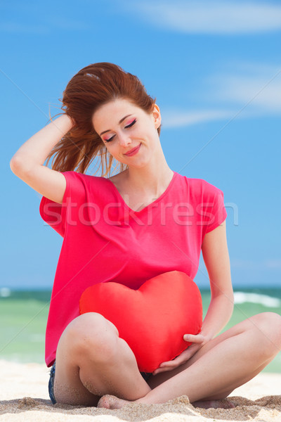 Redhead teen girl with heart shape on the beach Stock photo © Massonforstock