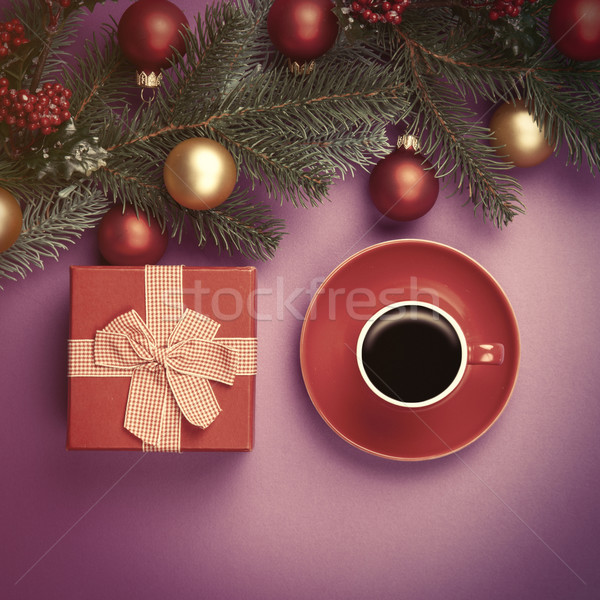 Hot coffee and pine branch with christmas toys on violet backgro Stock photo © Massonforstock