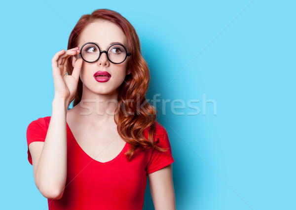 Kız kırmızı elbise gözlük şaşırmış mavi Stok fotoğraf © Massonforstock