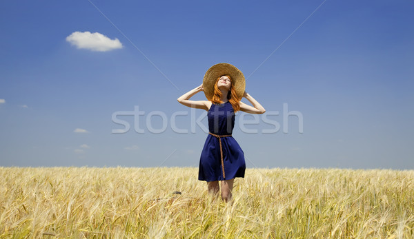 Redhead girl at spring wheat field. Stock photo © Massonforstock