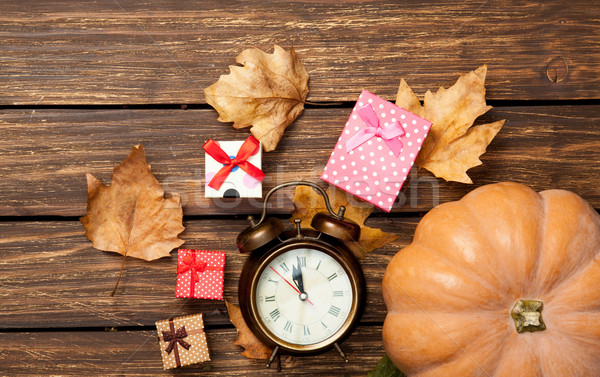 Pumpkin and alarm-clock with gifts Stock photo © Massonforstock