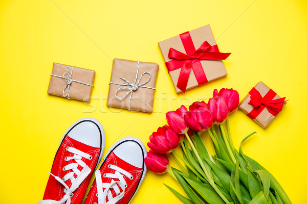bunch of red tulips, red gumshoes and beautiful gifts on the won Stock photo © Massonforstock