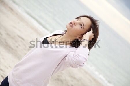 Stock photo: Pretty young woman with headphone on beach