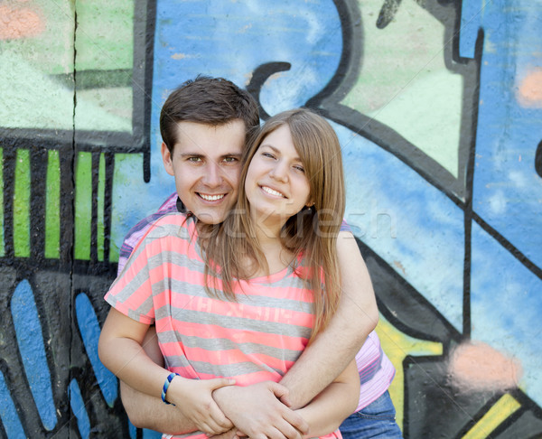 Young couple near graffiti background. Stock photo © Massonforstock