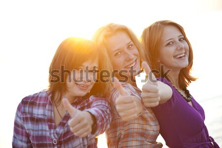Portrait of three beautiful girls. With counter light on backgro Stock photo © Massonforstock