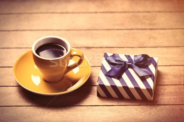 photo of cup of coffee and cute wrapped gift on the wonderful br Stock photo © Massonforstock