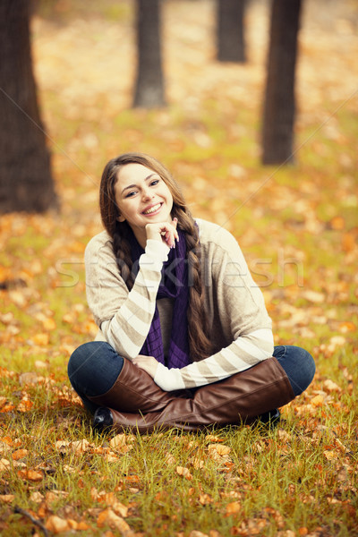 Smiling happy girl in autumn park. Stock photo © Massonforstock