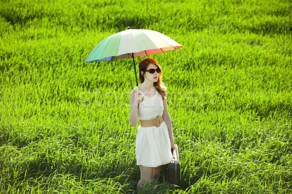 Redhead enchantress with umbrella and suitcase at spring country Stock photo © Massonforstock