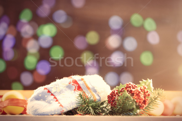 Stock photo: Mittens and gifts with Christmas lights 
