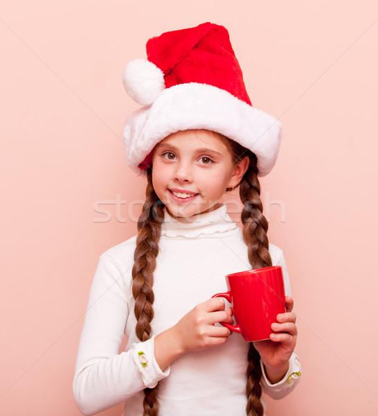girl with cup in Santa Claus hat Stock photo © Massonforstock