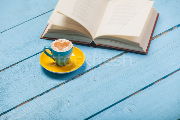 photo of cup of coffee and opened book on the wonderful blue woo Stock photo © Massonforstock