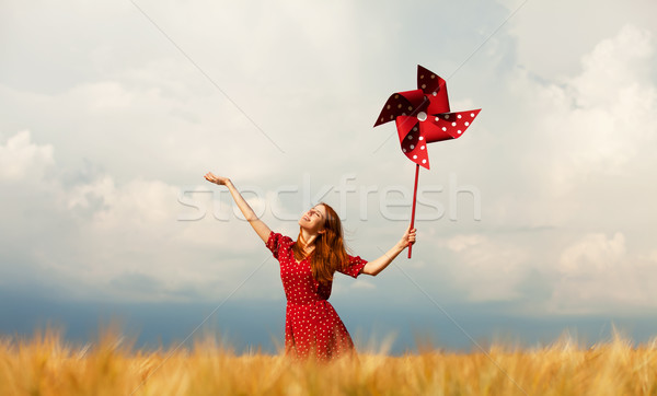 Redhead girl with toy wind turbine Stock photo © Massonforstock