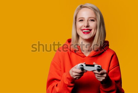Young housewife with PlayStation 4  Stock photo © Massonforstock